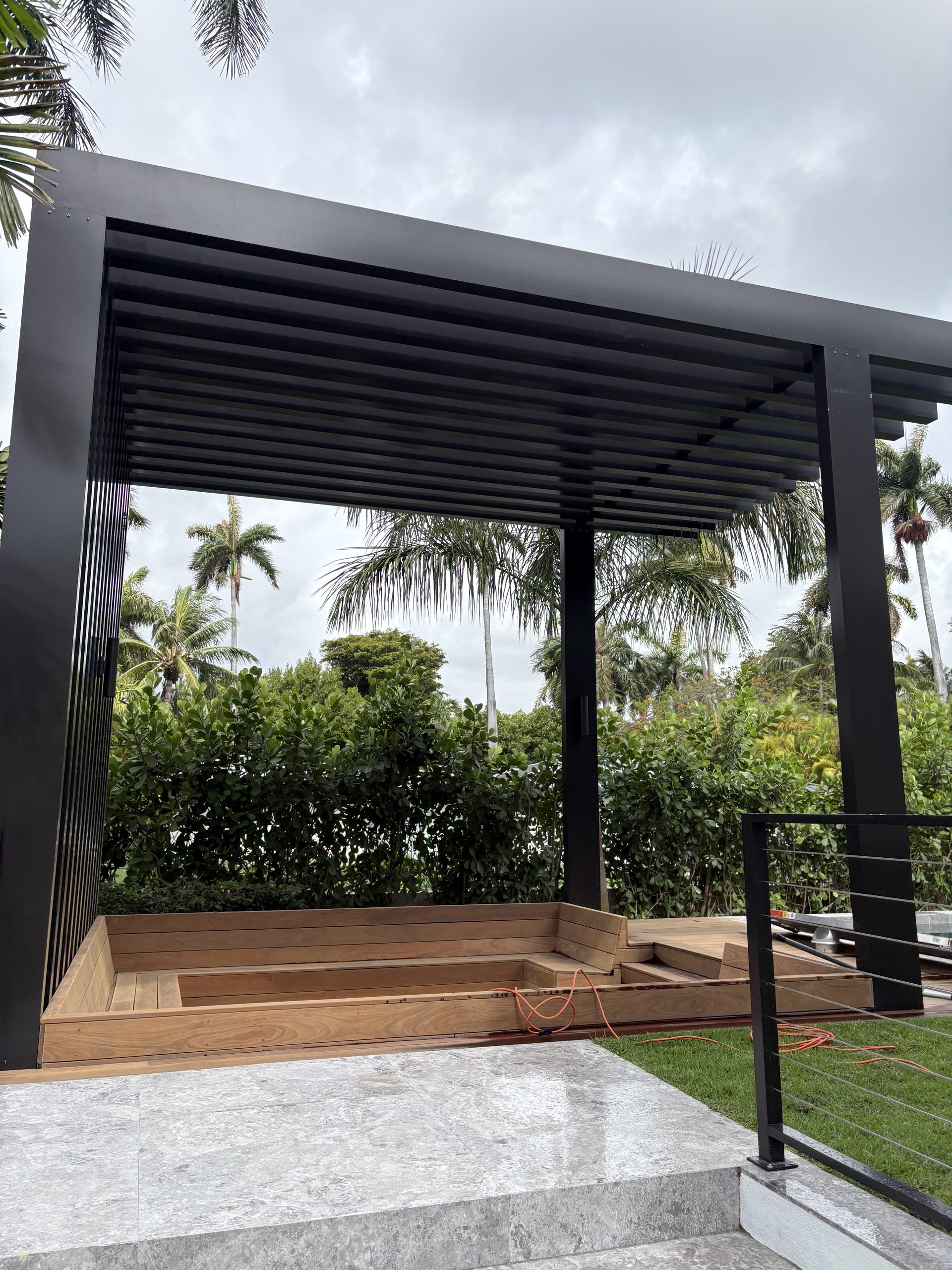 Aluminum pergola with built-in wood bench seating