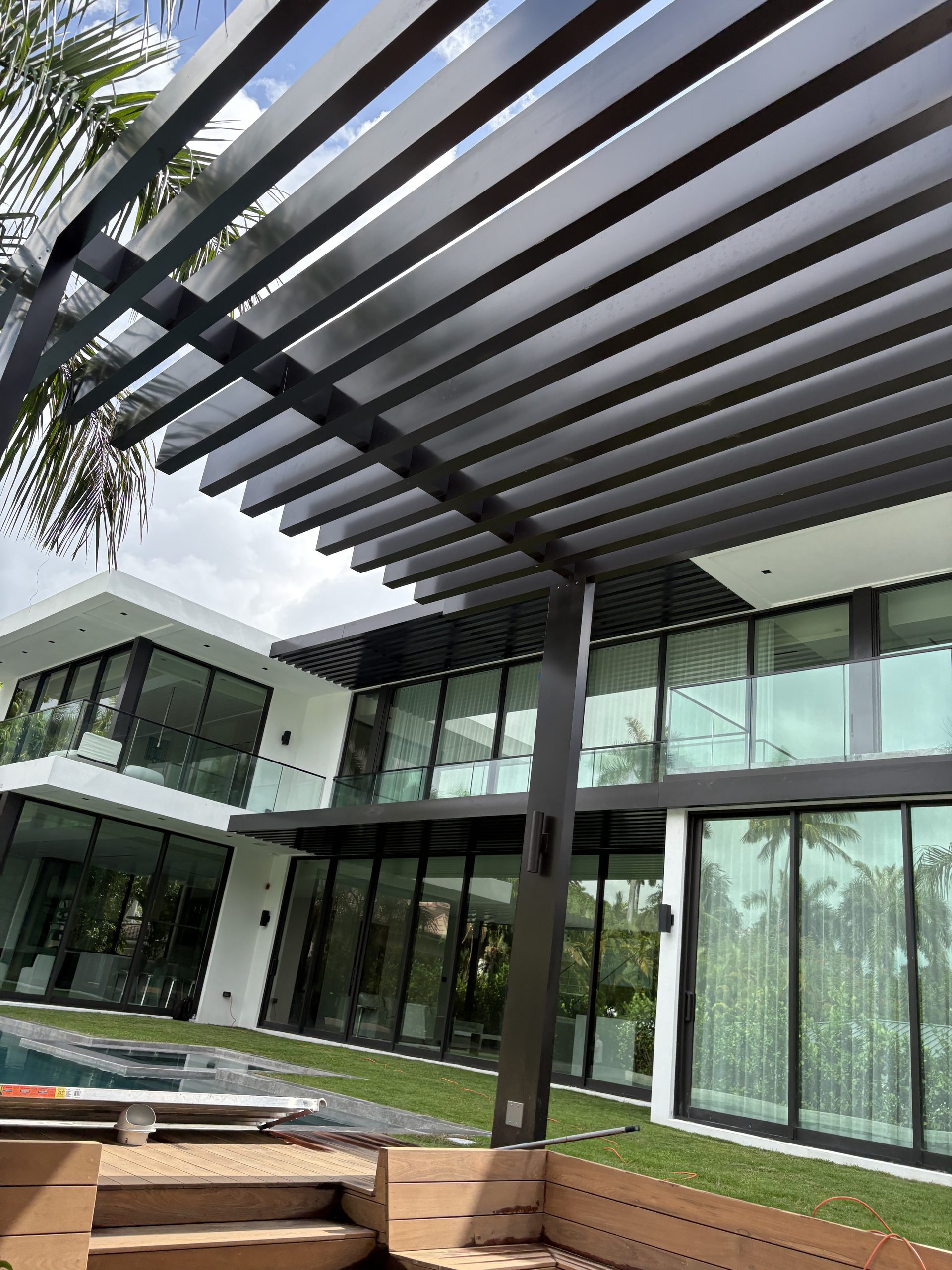 Modern black aluminum pergola over outdoor living space